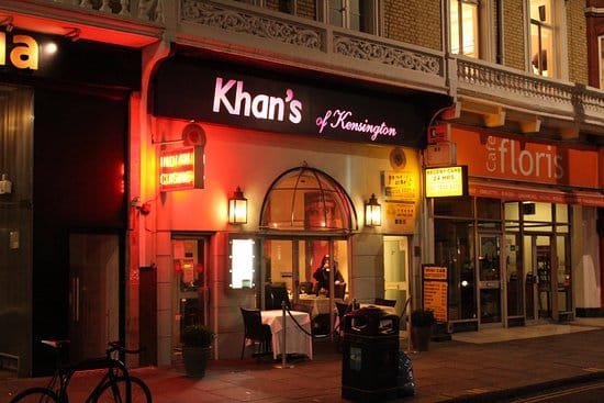 Picture of the exterior and sign of Khan's of Kensington lit up with neon lights